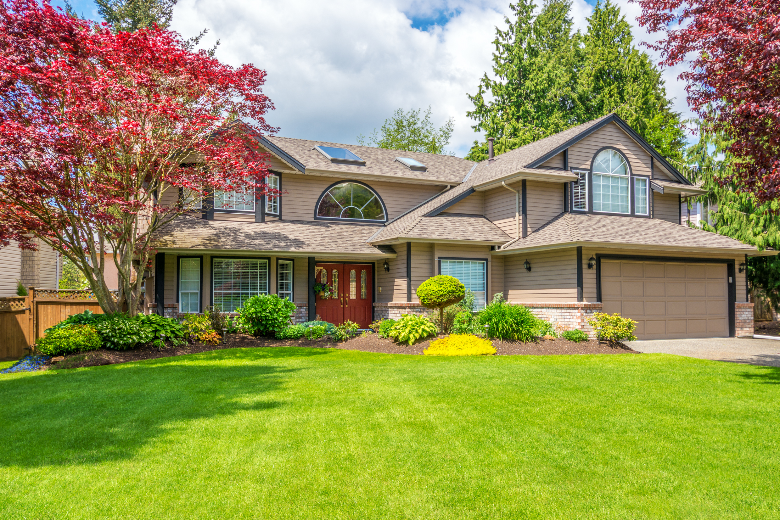 Two-story suburban home with a welcoming red door